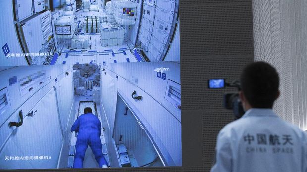 In this photo released by Xinhua News Agency, a worker monitors screens showing the interior of the Tianhe space station module after Chinese astronauts docked and enter it are displayed on large screens at the Beijing Aerospace Control Center in Beijing, on Thursday, June 17, 2021. China has launched the first three-man crew to its new space station in its the ambitious programs first crewed mission in five years (Jin Liwang/Xinhua via AP)