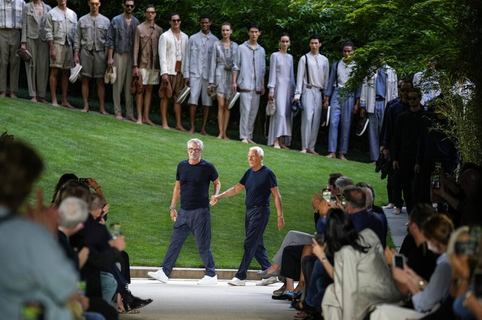 Models wear creations as part of the Giorgio Armani mens Spring Summer 2022 collection, in Milan, Italy, Monday, June 21, 2021. (AP Photo/Luca Bruno)