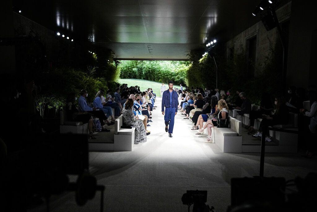 Models wear creations as part of the Giorgio Armani men's Spring Summer 2022 collection, in Milan, Italy, Monday, June 21, 2021. (AP Photo/Luca Bruno)