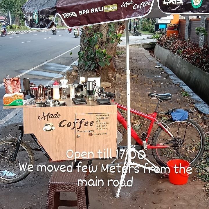 With few tourists, this tourist guide in Bali runs a mobile coffee business using a bicycle