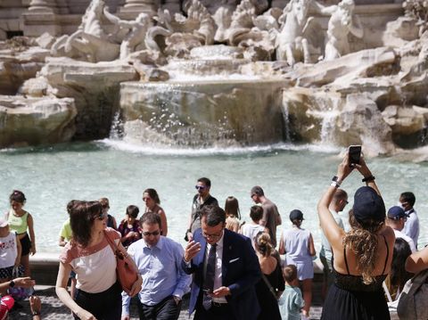 People gather in front of the Trevi fountain in Rome, Monday, June 28, 2021. Italians took off their face masks and breathed a huge sigh of relief on Monday as the government-imposed requirement on mask wearing outdoors was lifted. Italian Health Minister Roberto Speranza made the decision last week to lift the outdoor mask-wearing requirement on advice from Italy’s Scientific Technical Committee (CTS) that made the decision based on the stabilisation of Italy Covid-19 indicators. (Cecilia Fabiano/LaPresse via AP)