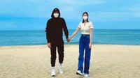 Kim Yoon Ji tidak memperlihatkan wajah calon suaminya, namun dalam foto terlihat keduanya bergandengan tangan di pantai dengan wajah tertutup masker. (Foto: dok. Instagram @_yunjeekim_) 