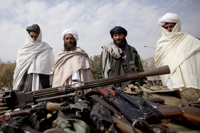 HERAT, AFGHANISTAN - OCTOBER 14:  Taliban fighters lay down their weapons as they surrender to the government of Herat Province on October 14, 2009 in Western Afghanistan.  More than 40 insurgents handed in their weapons in the wake of an ongoing government security operation which killed the Taliban commander in the Gazara district, Ghulam Yahya Akbari days ago.  (Photo by Majid/Getty Images)
