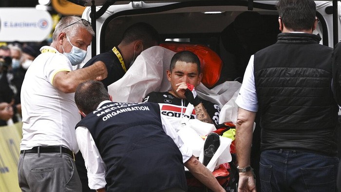 Australia's Caleb Ewan is carried into an ambulance after crashing in the sprint towards the finish line of the third stage of the Tour de France cycling race over 182.9 kilometers (113.65 miles) with start in Lorient and finish in Pontivy, France, Monday, June 28, 2021. (Anne-Christine Poujoulat/Pool Photo via AP)