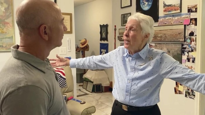 In this undated image from video provided by Blue Origin on Thursday, July 1, 2021, Mercury 13 astronaut trainee Wally Funk, right, meets with Jeff Bezos. On Thursday, Blue Origin announced the early female aerospace pioneer will be aboard the company’s July 20 launch from West Texas, flying as an “honored guest.” (Blue Origin via AP)