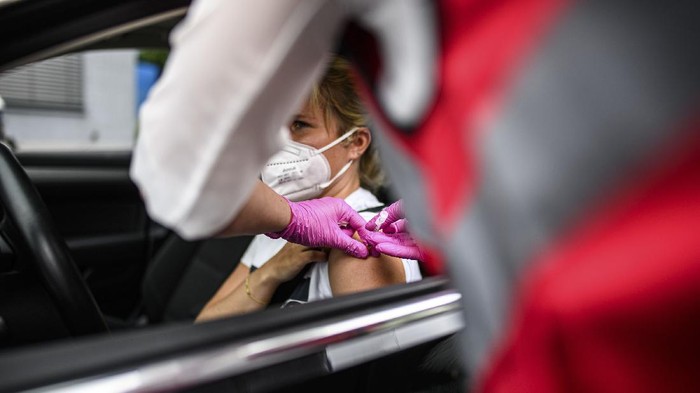 MEERBUSCH, GERMANY - JUNE 05: A doctor inoculates a local woman in a car with the Johnson and Johnson Janssen vaccine against Covid-19 at a special drive-in vaccination event on June 05, 2021 in Meerbusch, Germany. A local medical practice organized the vaccinations and is offering 3,000 doses of the vaccine to local residents today. Germany is making strong progress in its vaccination program, with approximately 45% of the population having received a first dose. (Photo by Lukas Schulze/Getty Images)