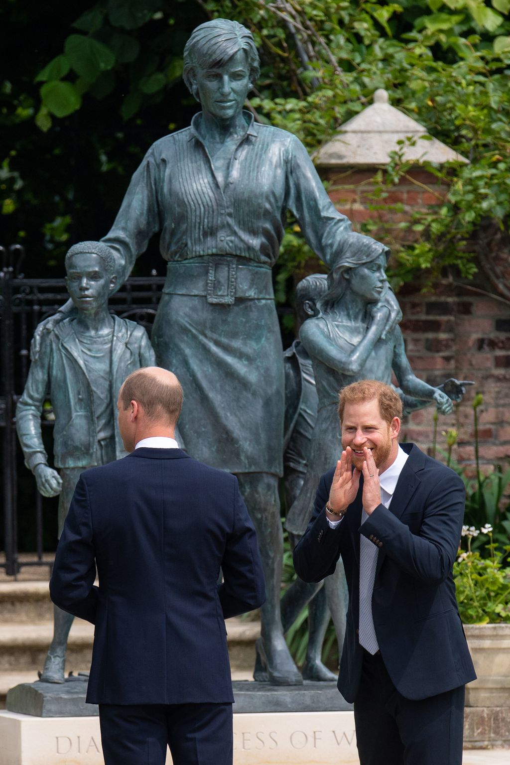 LONDON, ENGLAND - JULY 01: Prince William, Duke of Cambridge (left) and Prince Harry, Duke of Sussex unveil a statue they commissioned of their mother Diana, Princess of Wales, in the Sunken Garden at Kensington Palace, on what would have been her 60th birthday on July 1, 2021 in London, England. Today would have been the 60th birthday of Princess Diana, who died in 1997. At a ceremony here today, her sons Prince William and Prince Harry, the Duke of Cambridge and the Duke of Sussex respectively, will unveil a statue in her memory. (Photo by Dominic Lipinski - WPA Pool/Getty Images)