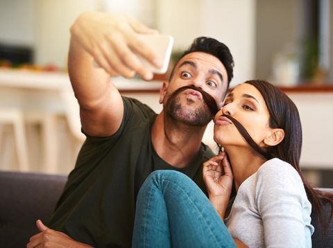 Shot of a young couple taking selfies together at home