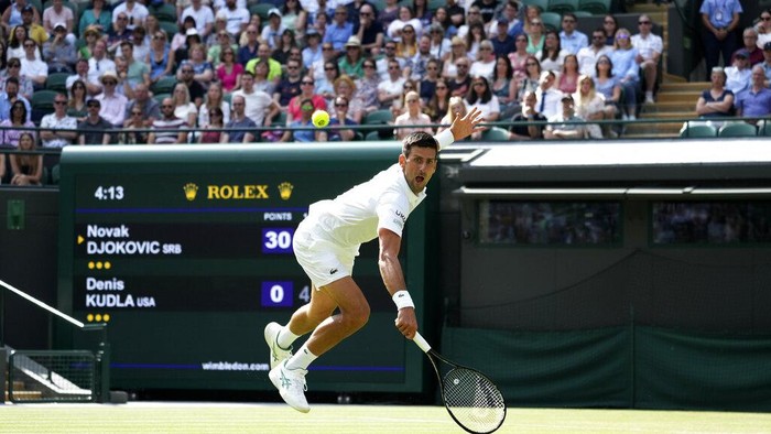 Serbias Novak Djokovic plays a return to Denis Kudla of the US during the mens singles third round match on day five of the Wimbledon Tennis Championships in London, Friday July 2, 2021. (AP Photo/Alberto Pezzali)