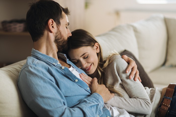 1286854139 Young affectionate couple enjoying together while man is kissing his girlfriend in head