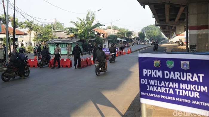 Sejumlah petugas memeriksa pengendara motor dan mobil di pos penyekatan Kalimalang, Jakarta. Pemeriksaan dilakukan sebagai bagian dari penerapan PPKM Darurat.