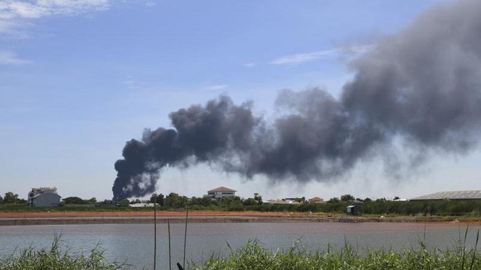 Smoke rises into the air from a factory in Samut Prakan province, Thailand, Monday, July 5, 2021. A massive explosion at the factory on the outskirts of Bangkok early Monday shook an airport terminal serving Thailands capital and prompted the evacuation of residents from the area. (AP Photo)