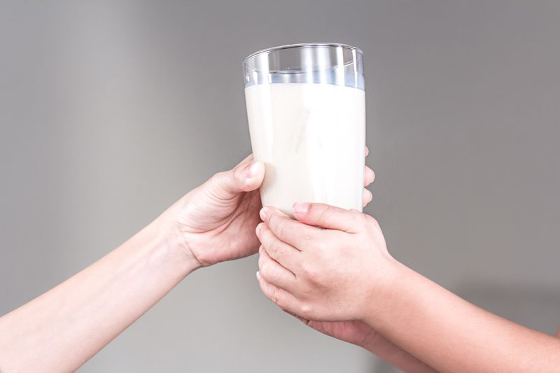 Mother and child holding a glass of milk