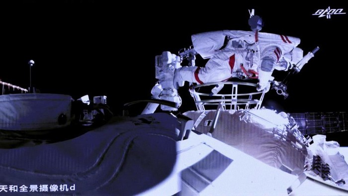 This photo released by Xinhua News Agency shows a screen at Beijing Aerospace Control Center showing astronaut Liu Boming stepping out of core module of the Chinas new space station in space on Sunday, July 4, 2021. Two astronauts made the first space walk on Sunday outside Chinas new orbital station to work on setting up a 15-meter (50-foot) long robotic arm. (Jin Liwang/Xinhua via AP)