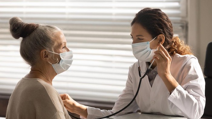 Woman holding a mask nebulizer inhaling fumes spray the medication into your lungs sick patient. Self-treatment of the respiratory tract using inhalation nebulizer