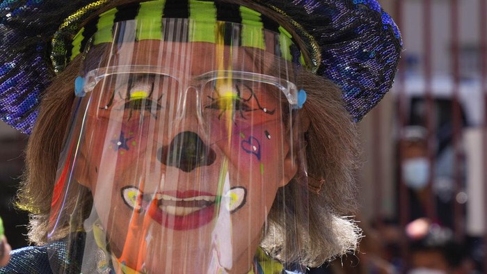 A clown gets a shot of the Sinopharm COVID-19 vaccine during a vaccination campaign targeting people between ages 18 and 30 at the public University San Andres in La Paz, Bolivia, Monday, July 5, 2021. (AP Photo/Juan Karita)