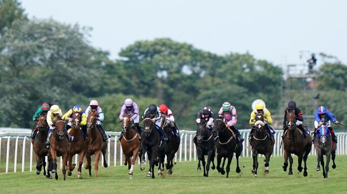 GREAT YARMOUTH, ENGLAND - JULY 7:  Mostallim ridden by Tom Marquand (centre) wins the quinnbet.com Handicap at Great Yarmouth Racecourse on July 7, 2021 in Great Yarmouth, England. (Photo by Tim Goode-Pool via Getty Images)
