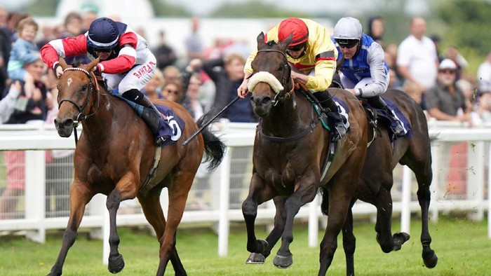 GREAT YARMOUTH, ENGLAND - JULY 7:  Mostallim ridden by Tom Marquand (centre) wins the quinnbet.com Handicap at Great Yarmouth Racecourse on July 7, 2021 in Great Yarmouth, England. (Photo by Tim Goode-Pool via Getty Images)
