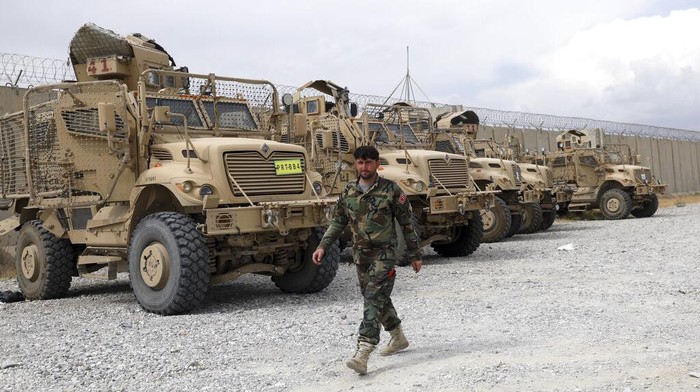 Ribuan Mobil Ditinggal Militer AS Usai Cabut dari Pangkalan Afghanistan A member of the Afghan security forces stands guard after the American military left Bagram air base, in Parwan province north of Kabul, Afghanistan, Monday, July 5, 2021. The U.S. left Afghanistan's Bagram Airfield after nearly 20 years, winding up its