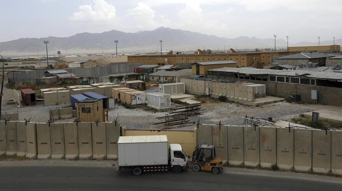 A member of the Afghan security forces stands guard after the American military left Bagram air base, in Parwan province north of Kabul, Afghanistan, Monday, July 5, 2021. The U.S. left Afghanistan's Bagram Airfield after nearly 20 years, winding up its 