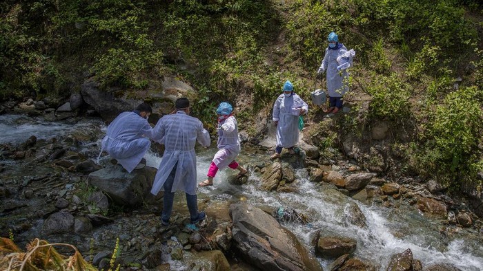 Masrat Farid, a healthcare worker, prepares to administer a dose of Covishield vaccine to Rubia Begum inside a hut during a COVID-19 vaccination drive in Gagangeer, northeast of Srinagar, Indian controlled Kashmir on June 22, 2021. Farid has traveled long distances to vaccinate mostly shepherds and nomadic herders in the remote meadows of the Himalayan region of Indian-controlled Kashmir. Her challenge has not been the treacherous terrain but to persuade women to get COVID-19 vaccines. “Everywhere we go it seems rumors reach earlier than we do, and it makes our job difficult,” Farid said recently during a vaccination campaign at a high altitude meadow. (AP Photo/Dar Yasin)