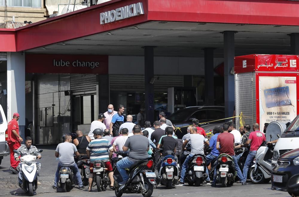 People on their scooters and motorcycles wait in queue for gasoline in Beirut, Lebanon, Friday in Beirut, Lebanon, Wednesday, June 23, 2021. Lebanon is struggling amid a 20-month-old economic and financial crisis that has led to shortages of fuel and basic goods like baby formula, medicine and spare parts. The crisis is rooted in decades of corruption and mismanagement by a post-civil war political class. (AP Photo/Hussein Malla)