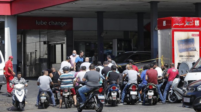 People on their scooters and motorcycles wait in queue for gasoline in Beirut, Lebanon, Friday in Beirut, Lebanon, Wednesday, June 23, 2021. Lebanon is struggling amid a 20-month-old economic and financial crisis that has led to shortages of fuel and basic goods like baby formula, medicine and spare parts. The crisis is rooted in decades of corruption and mismanagement by a post-civil war political class. (AP Photo/Hussein Malla)