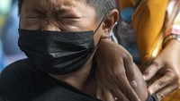 Seorang anak meringis saat jarum disuntikkan di lengan kirinya. Dia bersama sejumlah anak lainnya divaksinasi di RSUP Dr Mohammad Hoesin Palembang, Sumatera Selatan, Sabtu (10/7/2021).