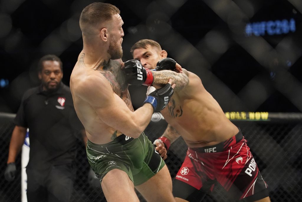 Conor McGregor, left, tries to avoid a punch from Dustin Poirier during a UFC 264 lightweight mixed martial arts bout Saturday, July 10, 2021, in Las Vegas. (AP Photo/John Locher)