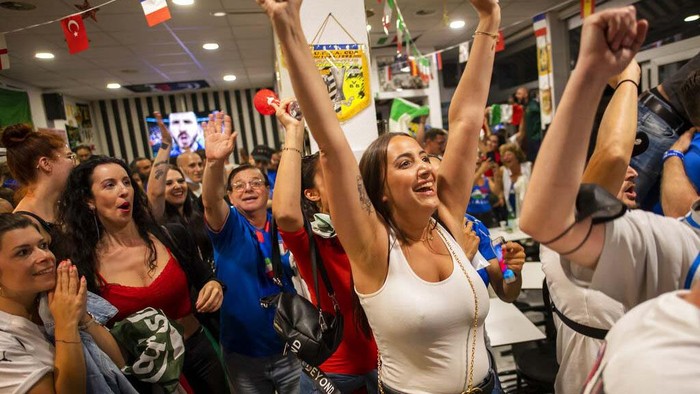 Italian fans living in Switzerland celebrate the victory after Italy beat England to win the Euro 2020 soccer championships, in Lausanne, Switzerland, Sunday, July 11, 2021. (Jean-Christophe Bott/Keystone via AP)