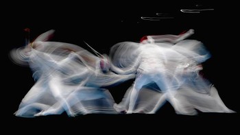 Foto dengan menggunkan Teknik slow speed ini diambil saat atlet anggar Ines Boubakri dari Tunisia (kanan) dan Eleanor Harvey dari Kanada bersaing dalam perempat final foil individu putri di Rio de Janeiro, Brazil. Matthias Hangst/Getty Images.