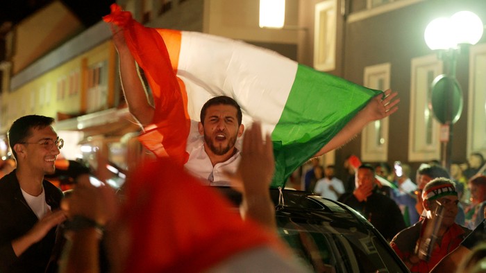 Fans of Italy's soccer team celebrate in the streets of Neuwied, Germany early Monday, July 12, 2021. Italy won the European Championship for the second time by beating England 3-2 on penalties on Sunday. (Thomas Frey/dpa via AP)