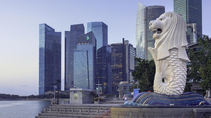View of the merlion statue of Merlion Park, and the financial district in downtown Singapore. The merlion is a symbol and mascot of Singapore.