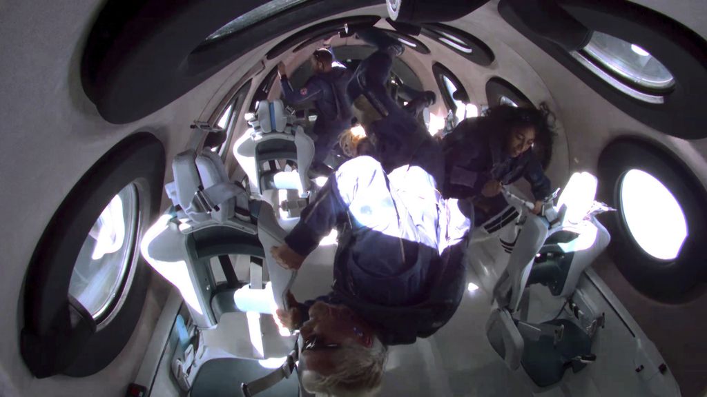 In this photo provided by Virgin Galactic, Richard Branson, bottom center, and his crew members experience zero gravity aboard his winged rocket ship on Sunday, July 11, 2021. Branson and five crewmates from his Virgin Galactic space-tourism company reached an altitude of about 53 miles (88 kilometers) over the New Mexico desert — enough to experience three to four minutes of weightlessness and see the curvature of the Earth.   (Virgin Galactic via AP)
