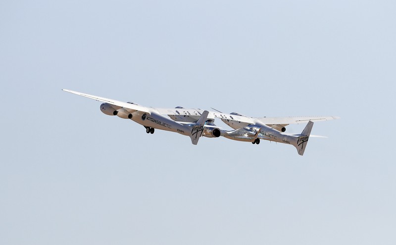 Special guests chat as they wait for Virgin Galactic founder Richard Branson's launch to space aboard his own rocket ship near Truth or Consequences, New Mexico, Sunday, July 11, 2021. (AP Photo/Andres Leighton)