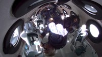 In this photo provided by Virgin Galactic, Richard Branson, bottom center, and his crew members experience zero gravity aboard his winged rocket ship on Sunday, July 11, 2021. Branson and five crewmates from his Virgin Galactic space-tourism company reached an altitude of about 53 miles (88 kilometers) over the New Mexico desert — enough to experience three to four minutes of weightlessness and see the curvature of the Earth.   (Virgin Galactic via AP)