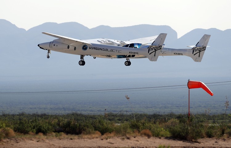 Special guests chat as they wait for Virgin Galactic founder Richard Bransons launch to space aboard his own rocket ship near Truth or Consequences, New Mexico, Sunday, July 11, 2021. (AP Photo/Andres Leighton)