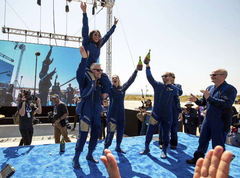 Special guests chat as they wait for Virgin Galactic founder Richard Branson's launch to space aboard his own rocket ship near Truth or Consequences, New Mexico, Sunday, July 11, 2021. (AP Photo/Andres Leighton)