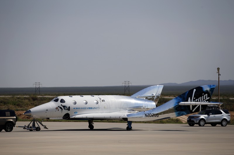 Special guests chat as they wait for Virgin Galactic founder Richard Branson's launch to space aboard his own rocket ship near Truth or Consequences, New Mexico, Sunday, July 11, 2021. (AP Photo/Andres Leighton)