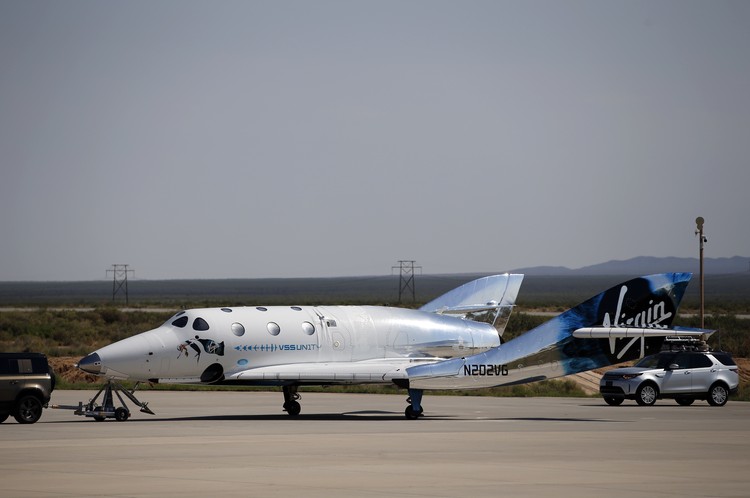 Special guests chat as they wait for Virgin Galactic founder Richard Bransons launch to space aboard his own rocket ship near Truth or Consequences, New Mexico, Sunday, July 11, 2021. (AP Photo/Andres Leighton)