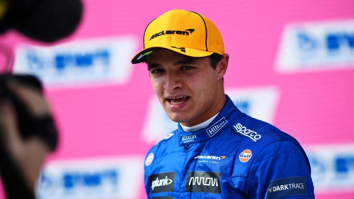 SPIELBERG, AUSTRIA - JULY 03: Second place qualifier Lando Norris of Great Britain and McLaren F1 talks to the media in parc ferme during qualifying ahead of the F1 Grand Prix of Austria at Red Bull Ring on July 03, 2021 in Spielberg, Austria. (Photo by Christian Bruna - Pool/Getty Images)