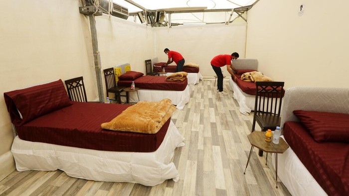Workers set up accommodations for pilgrims at a tent camp in Mina, near the Muslim holy city of Mecca, ahead of the upcoming annual hajj pilgrimage, Monday, July 12, 2021. The pilgrimage to Mecca required once in a lifetime of every Muslim who can afford it and is physically able to make it, used to draw more than 2 million people. But for a second straight year it has been curtailed due to the coronavirus with only vaccinated people in Saudi Arabia able to participate. (AP Photo/Amr Nabil)