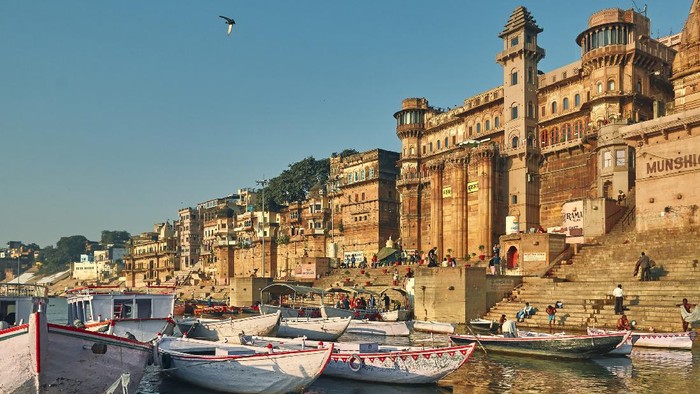 Varanasi cityscape. The city is on the banks of river Ganga. Boats waiting at the ghats. pictured here is Munshi ghat. There are numerous ghats throughout the length of riverbanks.

Varanasi@ Uttar Pradesh is one the oldest living heritage cities of world and called spiritual capital of India. Though the city and its people have adopted new times, but still much of city has preserved the old charm. A unique mixture of old and modern times attracts travellers from all over the world.
Photo taken at Munshighat, Varanasi, Uttar Pradesh on 11/17/2018