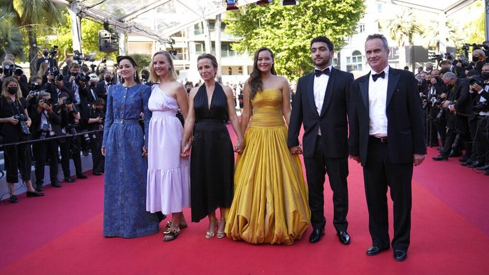 Mary Finn, from left, Marion Cotillard, Melati Wijsen, and Mohamad Al Jounde pose for photographers at the photo call for the film 'Bigger Than Us' at the 74th international film festival, Cannes, southern France, Saturday, July 10, 2021. (Photo by Vianney Le Caer/Invision/AP)