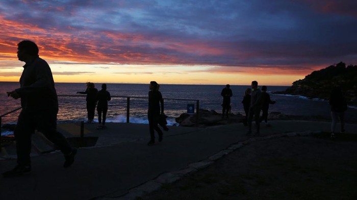 SYDNEY, AUSTRALIA - JULY 14: People exercise along the Bondi coastal walk on July 14, 2021 in Sydney, Australia. Lockdown restrictions remain in place across Greater Sydney, the Blue Mountains, the Central Coast and Wollongong with all residents subject to stay-at-home orders. People are only permitted to leave their homes for essential reasons, including purchasing essential goods, accessing or providing care or healthcare, work, education and exercise within a 10km radius from home or within the local government area, and with a maximum of two people per group. Browsing in shops is prohibited and only one person per household can leave home for shopping per day. Outdoor public gatherings are limited to two people, while funerals are limited to 10 people only. (Photo by Lisa Maree Williams/Getty Images)