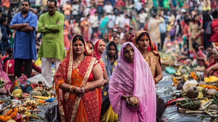 New Delhi, Delhi/ India- November 02 2019 : Women of India celebrating Chhath Pooja by drowning themselves in Water for praying to sun.