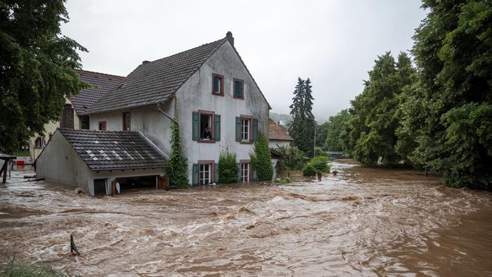 Houses are submerged on the overflowed river banks in Erdorf, Germany, as the village was flooded Thursday, July 15, 2021. Continuous rainfall has flooded numerous villages and cellars in Rhineland-Palatinate, southwestern Germany. (Harald Tittel/dpa via AP)