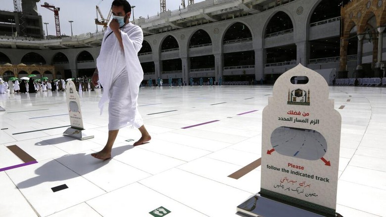 Jemaah Tiba di Mekkah, Siap Mulai Rangkaian Haji A Saudi police woman, left, who is recently deployed to the service, at top left, stands alert in front of the Al-Safa mountain, as pilgrims pray at the Grand Mosque, at the Grand Mosque, a day before the annual hajj pilgrimage, Saturday, July 17, 2021. The pilgrimage to Mecca required once in a lifetime of every Muslim who can afford it and is physically able to make it, used to draw more than 2 million people. But for a second straight year it has been curtailed due to the coronavirus with only vaccinated people in Saudi Arabia able to participate. (AP Photo/Amr Nabil)
