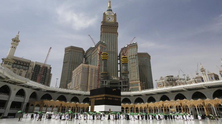 Jemaah Tiba di Mekkah, Siap Mulai Rangkaian Haji A Saudi police woman, left, who is recently deployed to the service, at top left, stands alert in front of the Al-Safa mountain, as pilgrims pray at the Grand Mosque, at the Grand Mosque, a day before the annual hajj pilgrimage, Saturday, July 17, 2021. The pilgrimage to Mecca required once in a lifetime of every Muslim who can afford it and is physically able to make it, used to draw more than 2 million people. But for a second straight year it has been curtailed due to the coronavirus with only vaccinated people in Saudi Arabia able to participate. (AP Photo/Amr Nabil)