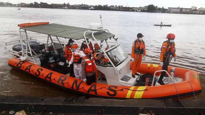 Potret Evakuasi Korban Kapal Tenggelam di Perairan Kalbar Dua petugas medis menuntun Purwanto (tengah), awak Kapal Motor Usaha Abadi yang selamat dari kecelakaan kapal tenggelam saat tiba di dermaga Pelabuhan Kantor Kesyahbandaran dan Otoritas Pelabuhan Pontianak, Kalimantan Barat, Jumat (16/7/2021). Hingga saat ini Basarnas masih melakukan pencarian terhadap 44 awak dari 16 kapal motor yang tenggelam di Perairan Kalbar akibat cuaca buruk pada Selasa (13/7/2021) malam dan Rabu pagi (14/7/2021). ANTARA FOTO/Jessica Helena Wuysang/hp.
